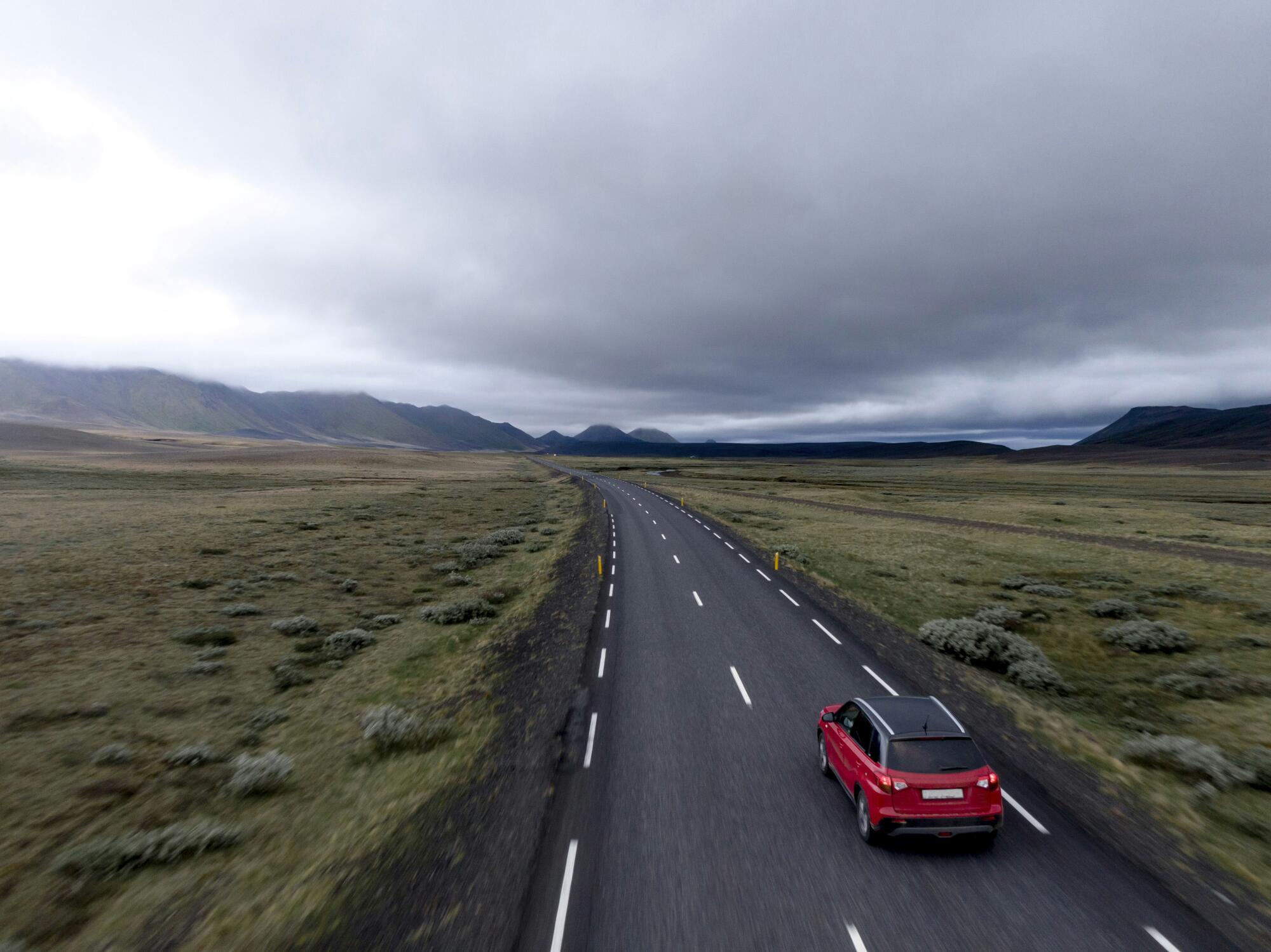 Red-Car-Driving-On-Country-Roa
